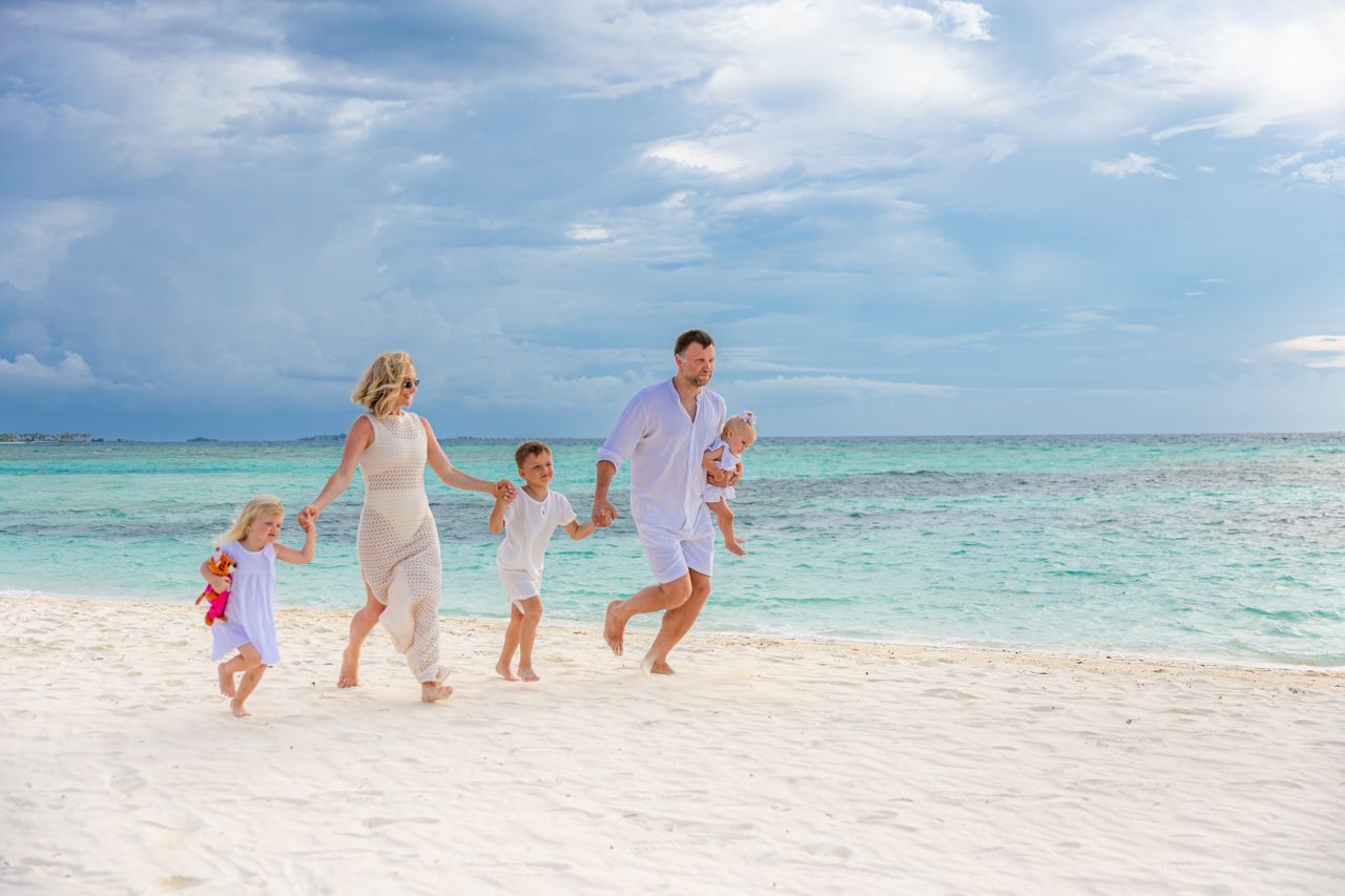 Menu A joyful family strolls along a tropical beach, enjoying a sunny day together.